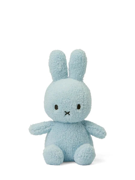 A light blue plush bunny toy with large ears and a small black mouth.