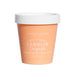 A container of Lanolin Origins Manuka Honey Body Balm, with a white lid and a peach-colored exterior.