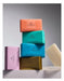 A stack of six colorful soap bars with the brand name "GLASHOUSE" printed on them.