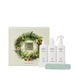 a gift set with three white bottles and a spray bottle, all labeled with the brand name 'CIRCA'. The gift set is presented next to a white box with a wreath design, and there is a green towel placed in front of the gift set.