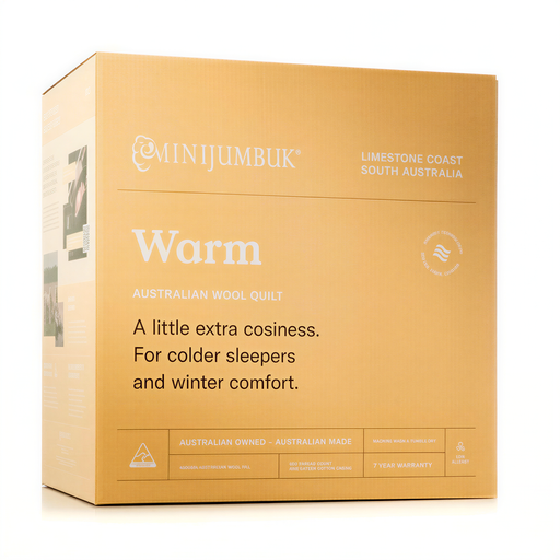 The image is a cardboard box for a product called "Warm", which is an Australian wool quilt. The box is described as having a little extra cosiness for colder sleepers and winter comfort. It is made by Australian Owned - Australian Made and is a low-allergen product. The box also includes a 7-year warranty.