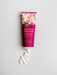 A tube of sweet pea and rose myrtle lotion with organic shea butter is shown against a white background.
