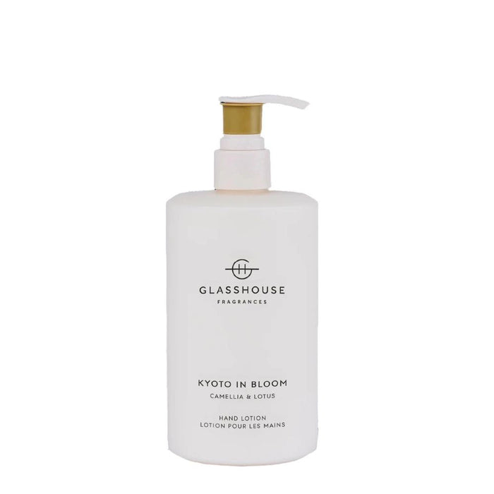 A white pump bottle with a gold pump cap, containing a hand lotion product labeled "KYOTO IN BLOOM CAMPELLULA & LOTUS".