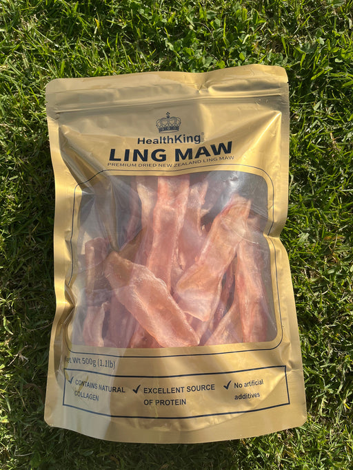 A package of raw meat, specifically chicken maw, laid on the grass.