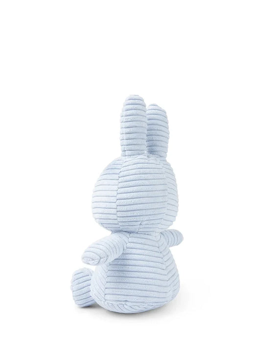 A light blue stuffed bunny toy is sitting on a white background.