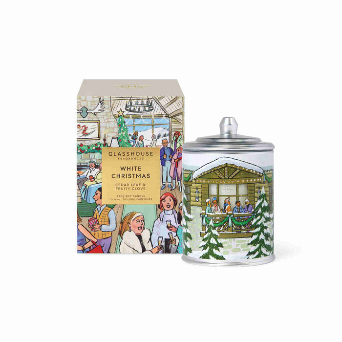 a box of tea and a tin can with a Christmas-themed design, both sitting next to each other.
