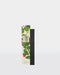 a set of black reed diffuser sticks with a white and green floral design on the packaging.