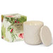 A white ceramic candle with a floral design and a matching lid, placed next to its packaging box.