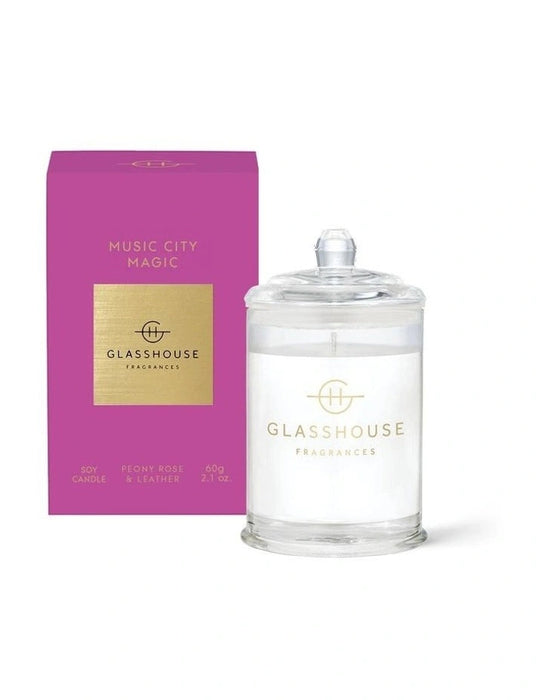 a pink box and a clear glass jar with a lid, both labeled with the brand "GLASSHOUSE Fragrances".