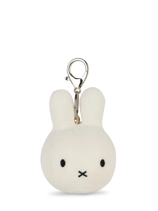 A white plush rabbit charm with black eyes and mouth, attached to a silver metal clasp.