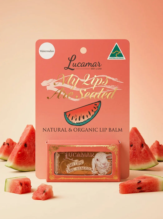 a product packaging for Lucamar lip balm, with a watermelon slice and a small tube of the lip balm in front of it.