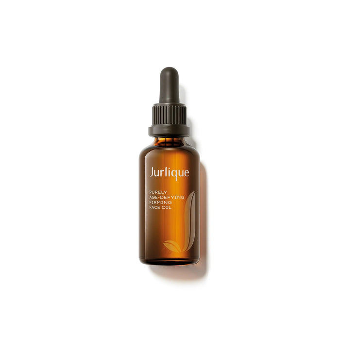 A brown glass bottle with a black dropper, containing a brown liquid, and labeled as a face oil product from the brand Jurlique.