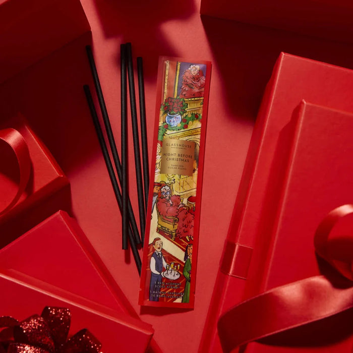 a red box with a colorful illustration and text, surrounded by red gift boxes and black straws on a red background.