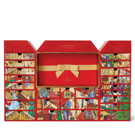 A red and gold advent calendar with a detailed illustration of various scenes and characters on the front and sides.