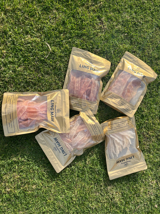 five packages of dried meat, specifically Ling Maw, arranged on a grassy surface.