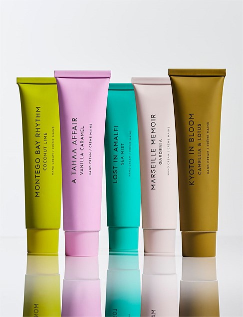 five tubes of body lotion arranged in a row, each with a different color.