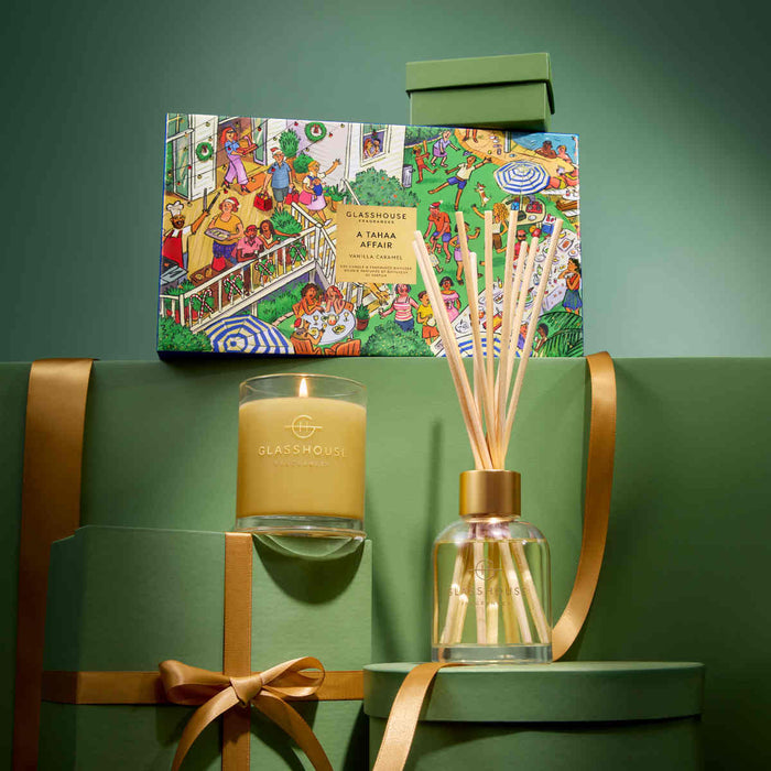 a collection of green gift boxes and a candle, with a clear glass jar containing a stick of incense.