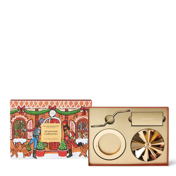 a box with a Christmas-themed illustration and a decorative fan, along with a fan and a small plate.