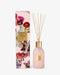 a pink glass diffuser and its packaging, which is adorned with a floral pattern.