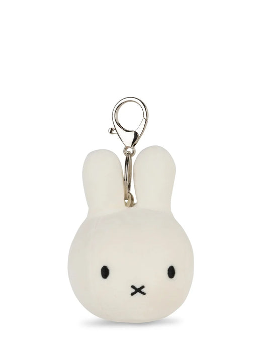 A white plush rabbit charm with black eyes and mouth, attached to a silver metal clasp.
