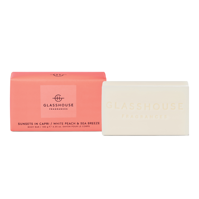 a pink box and a white bar of soap, both labeled with the brand name "GLASSHOUSE FRAGRANCES".
