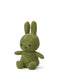 A green stuffed bunny toy with large ears and a small nose is sitting on a white background.