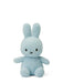 A light blue plush bunny toy with large ears and a small black mouth.