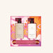 two bottles of Glasshouse fragrances, each with a pump dispenser, placed in a pink and orange box with a floral pattern.
