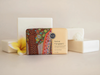 a bar of soap with a colorful, artistic design on it, surrounded by other white rectangular objects.
