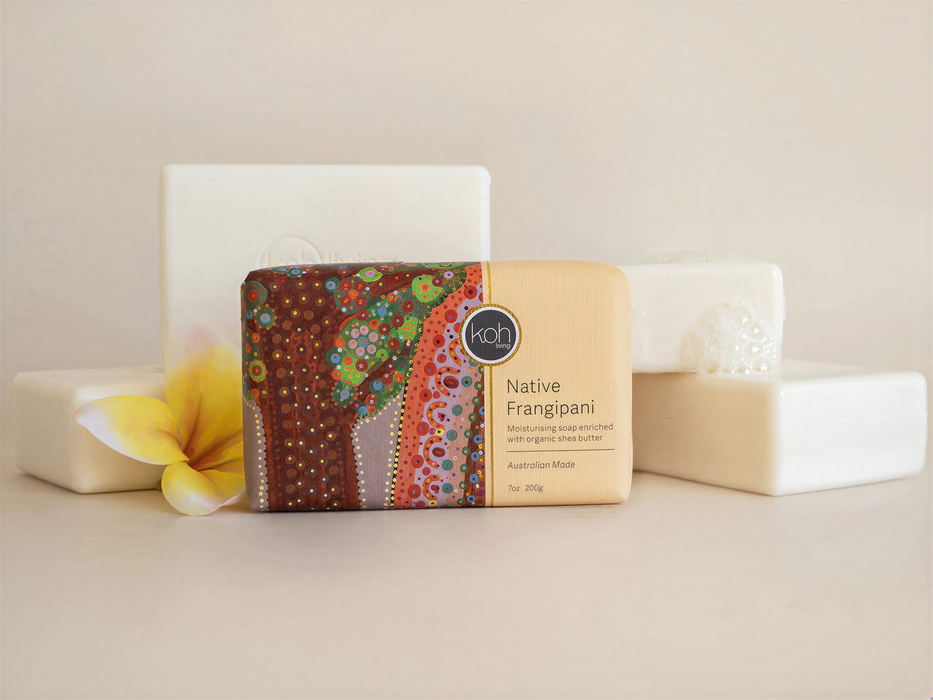 a bar of soap with a colorful, artistic design on it, surrounded by other white rectangular objects.