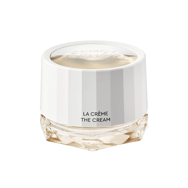 A white jar of La Creme The Cream skincare product against a black background.