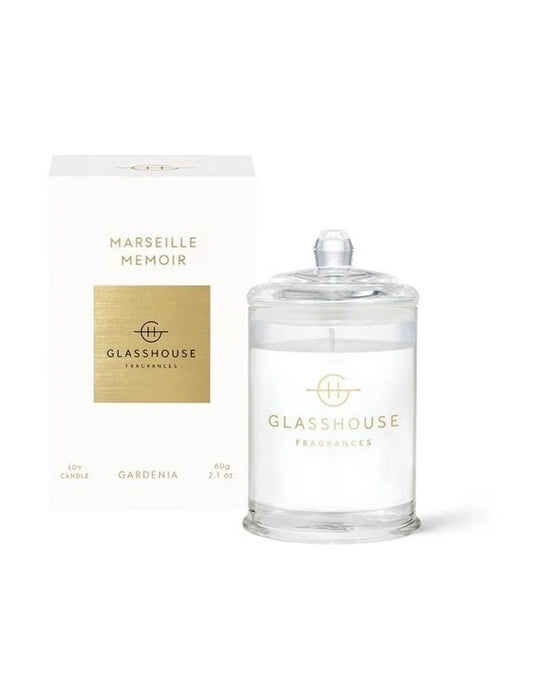 a glass jar candle labeled "Marseille Memoir" from "GLASSHOUSE Fragrances" and a box containing the same candle.