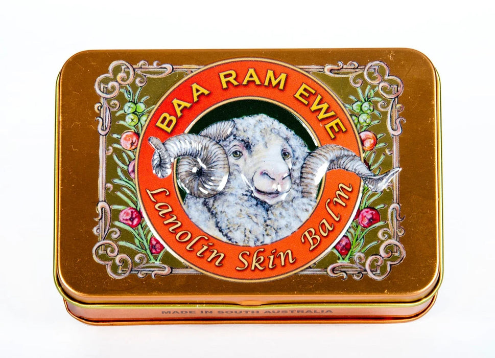 a tin can with a picture of a ram's head and the text "BAA RAM EWE Lanolin Skin Balm" around it.