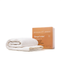 a folded white blanket and a cardboard box labeled "Sleeping Calm" next to each other.
