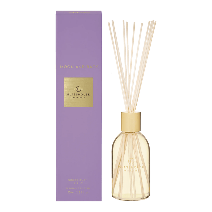 a purple box and a glass diffuser with white sticks, both labeled with the brand name "GLASSHOUSE" and the product name "Moon and Back".