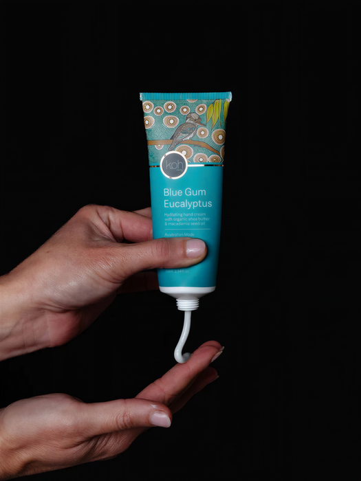 A person's hands holding a tube of blue gum eucalyptus.