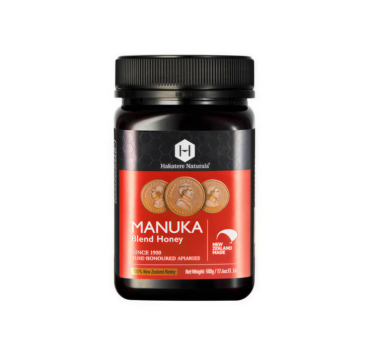 A bottle of Manuka Blend Honey from Hautee Natural, with a black cap and a red label featuring the product name and information.