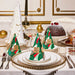 a beautifully set table with a variety of dishes, including a cake, a bowl of fruit, and other holiday-themed items. The table is adorned with gold and white decorations, and the overall scene conveys a festive and elegant atmosphere.
