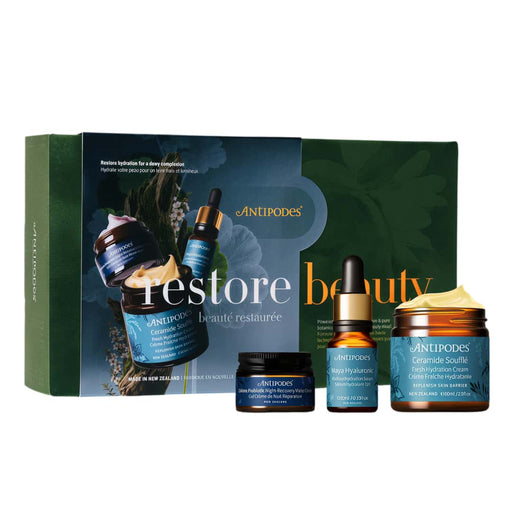 a set of four beauty products from the brand Antipodes, including a jar, a bottle, a tube, and a small jar.
