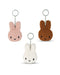three keychains with bunny heads in different colors: pink, white, and brown.