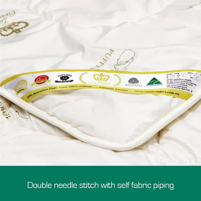 A close-up view of a white fabric with various logos and text, including a crown logo, indicating it is a luxury product.
