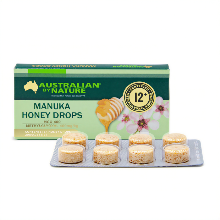 a box of Australian by Nature Manuka Honey Drops and a blister pack of the drops, both placed on a white background.
