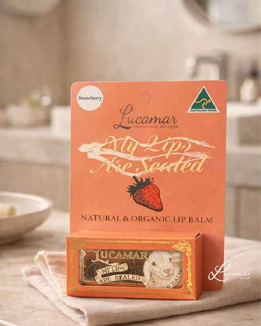 a product called "Lucamar My Lips Are Sealed" lip balm, which is a natural and organic lip balm. The product is displayed on a table, with a towel underneath it.