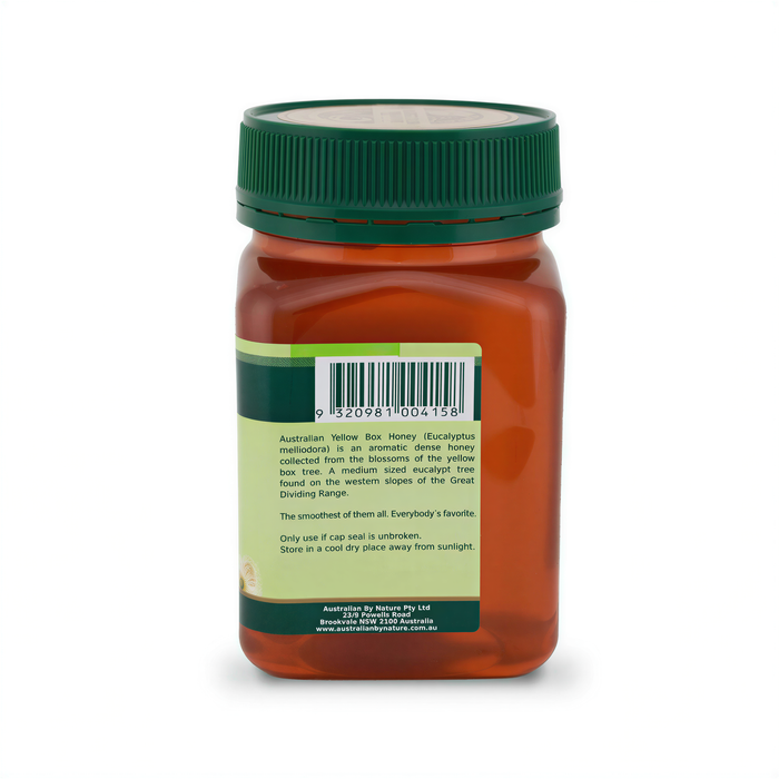 a bottle of honey with a green cap, and there is a barcode and some text on the label.