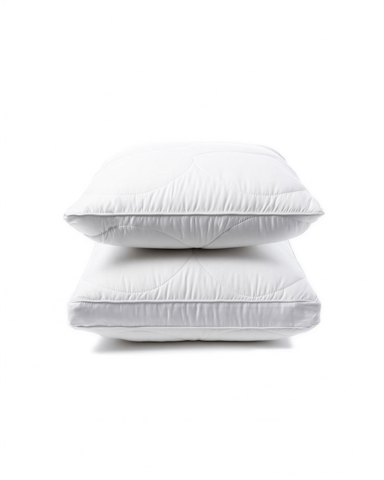 Two white pillows stacked on top of each other against a white background.