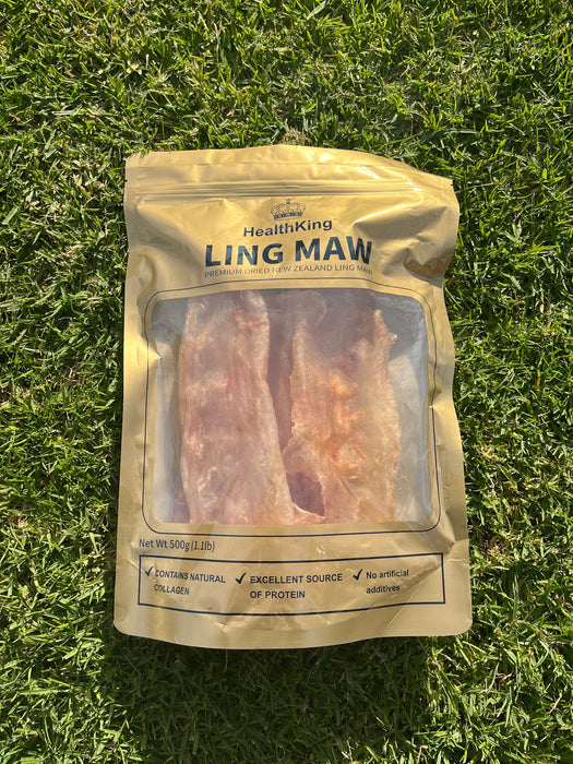 A package of dried meat, specifically "LING MAW", is lying on the grass.