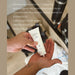 A person's hand holding a tube of CIRCA hand cream, with a focus on the product's features and benefits.