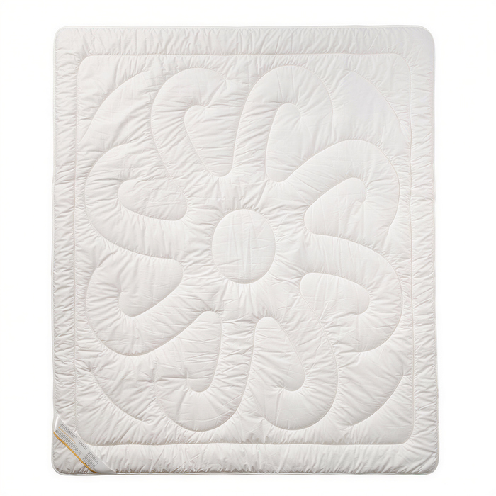 a white quilted bedspread or comforter with a flower-like pattern.
