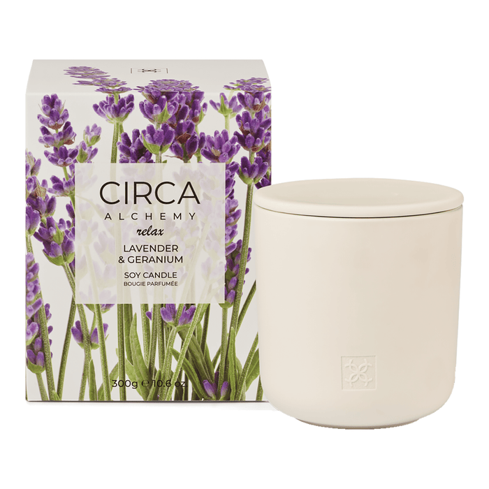 a white ceramic candle with a lavender and geranium scent, placed next to its packaging box.