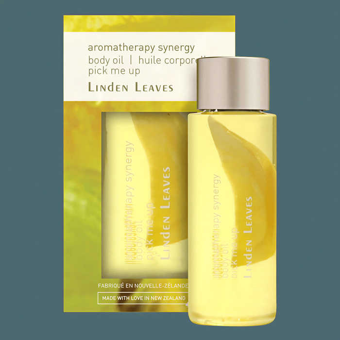 a bottle of Linden Leaves body oil and a box of the product.